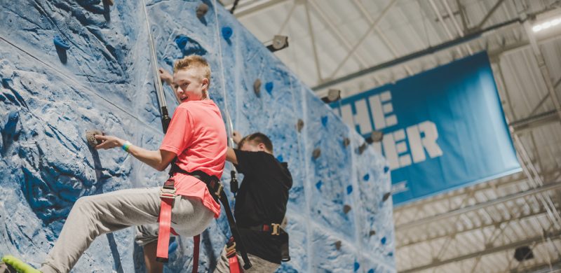 two guy climbing a vertical