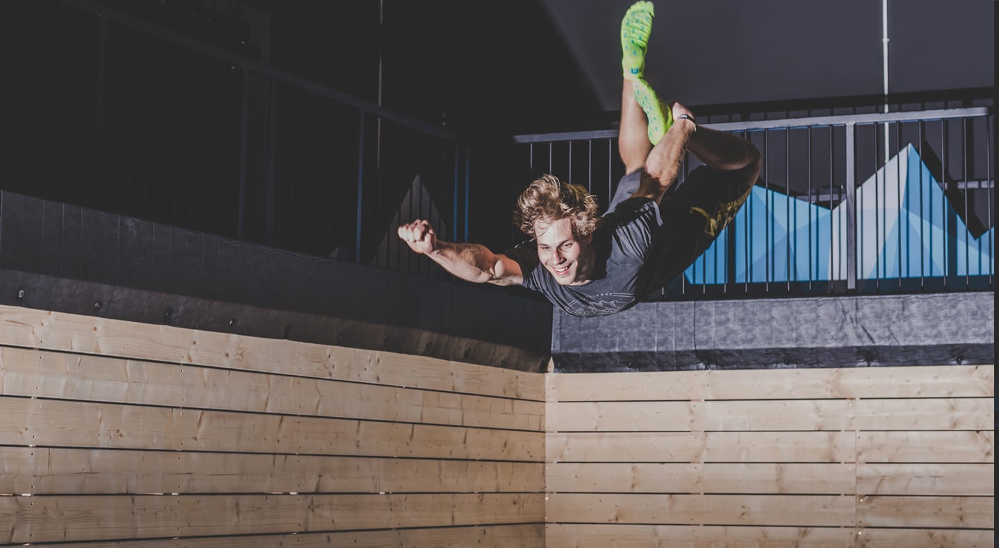single man jumping indoor trampoline