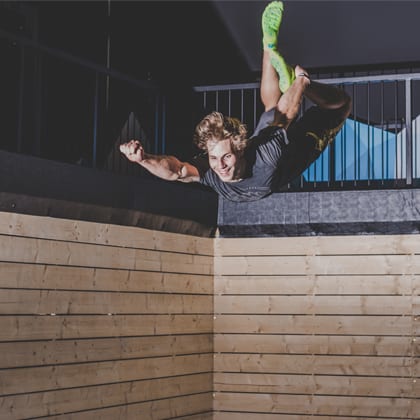 single man jumping indoors while posing