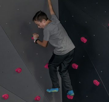 young-man-climbing-on-climbing-wall-House-of-Air