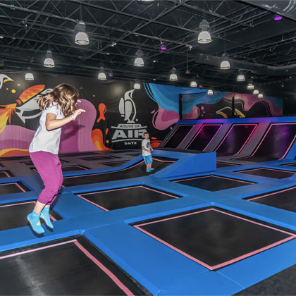 young male and female jump on main floor HOA