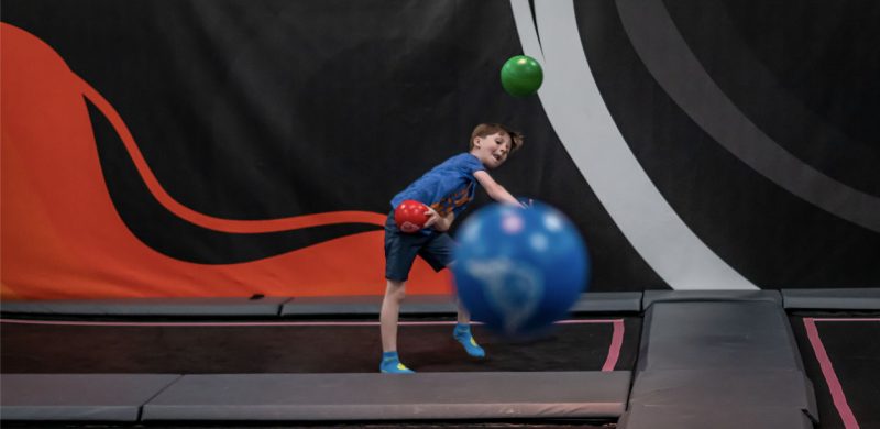 young male playing dodge ball at HOA