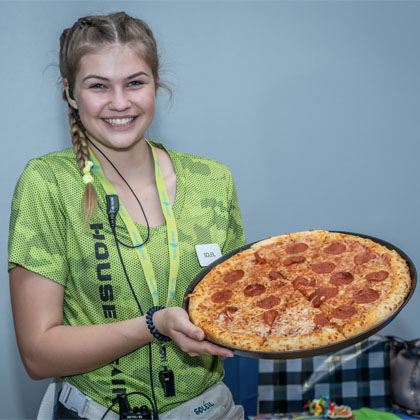 employee-female-holding-a-cheese-pizza-HOA