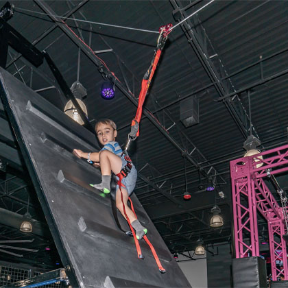 young male on the zip line obstacle HOA