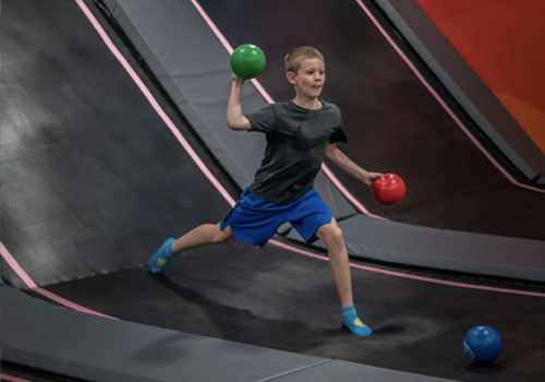 young male throwing foam ball in dodgeball San Antonio HOA